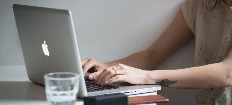 A woman working on a laptop.