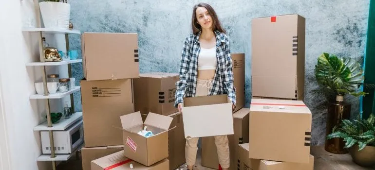 A woman among moving boxes