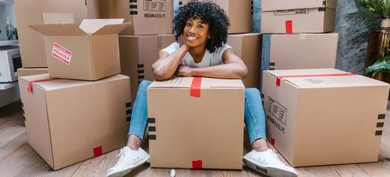 Woman surrounded by cardboard boxes