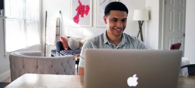 man looking online for movers Clarksburg MD has to offer