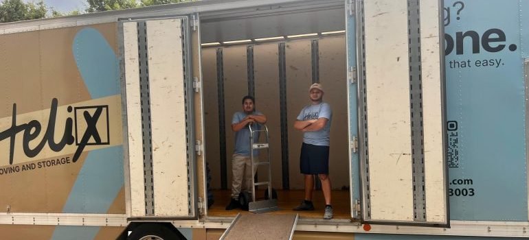 Two professional movers in a moving truck ready to help with moving to Silver Spring.