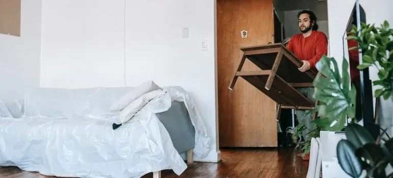 man carrying a table