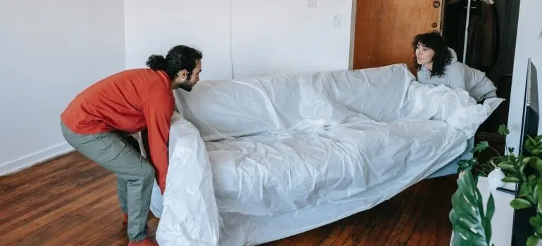 couple about to move bulky pieces of furniture