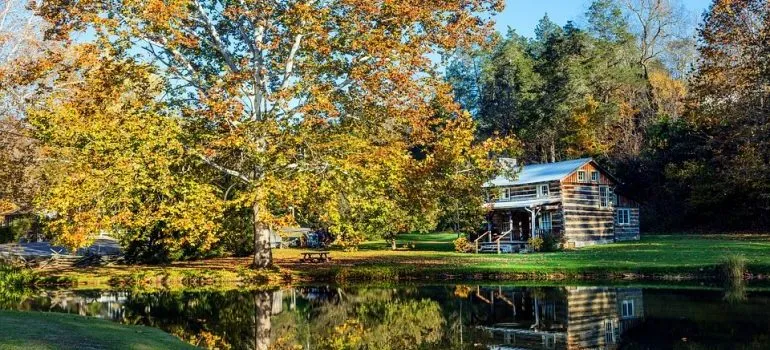 Cabin next to the lake and colorful trees
