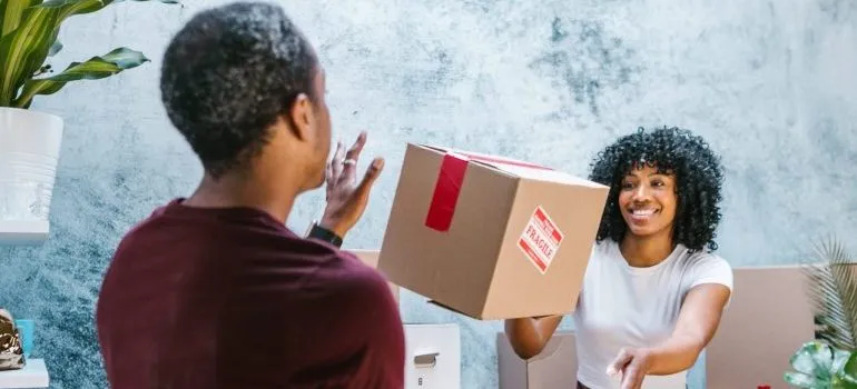 movers passing a cardboard box between them