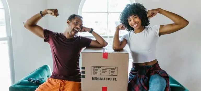 two people with a moving box