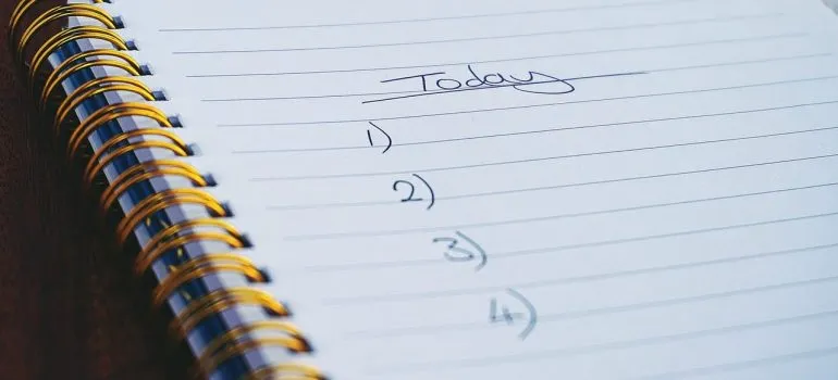 a checklist for today in a notebook representing how you should start creating your interstate move checklist