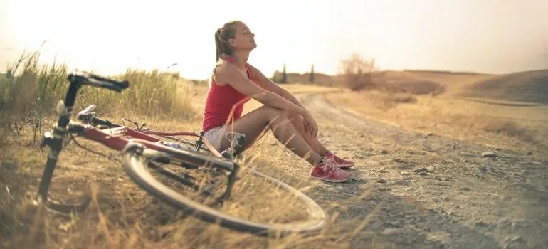 Woman resting by a bike