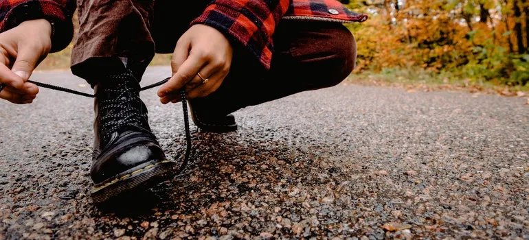 a person is tying their shoelaces.