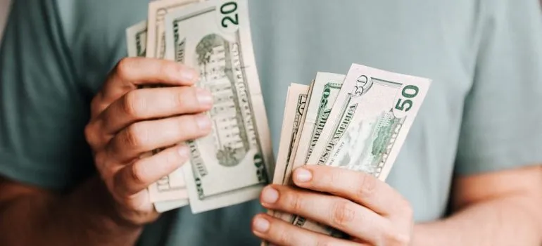 a man in a grey shirt counting money