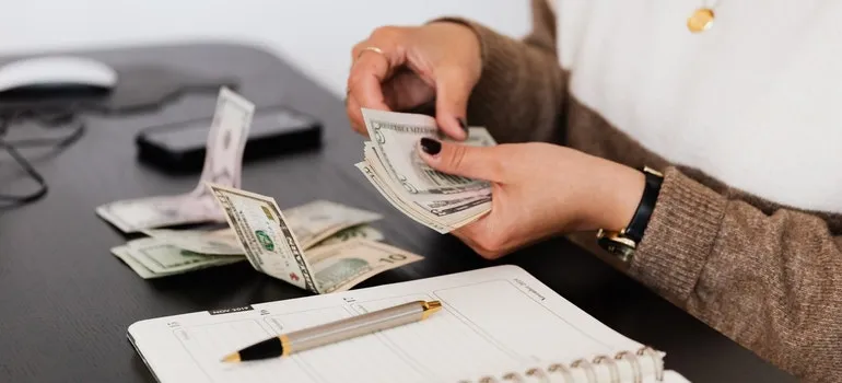 A woman counting money thinking about moving myths