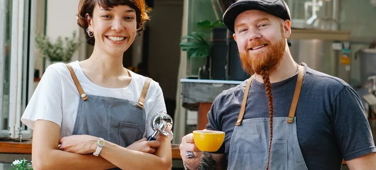 Two people are wearing working overalls.
