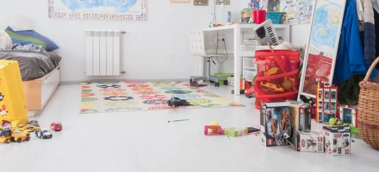 a baby nursery with various toys on the floor