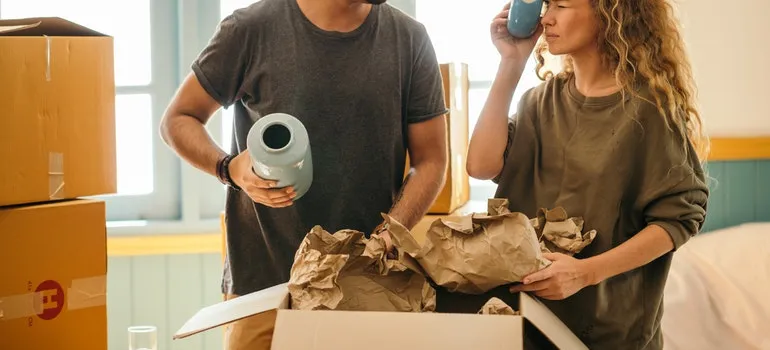 A woman and a man unpacking in order to settle after moving to Silver Spring.