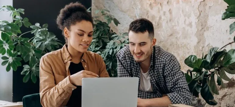 a couple looking at a laptop