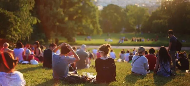 A group of people is sitting on the grass