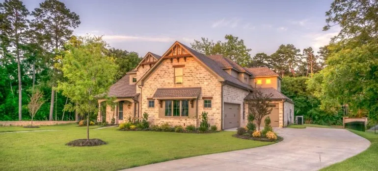 a brown-brick suburban home in the woods