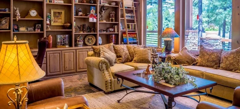 A living room with a couch, a coffee table, and many accessories