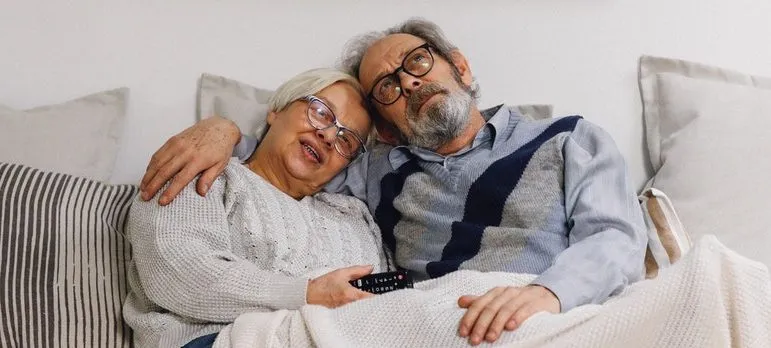 elderly couple on a sofa