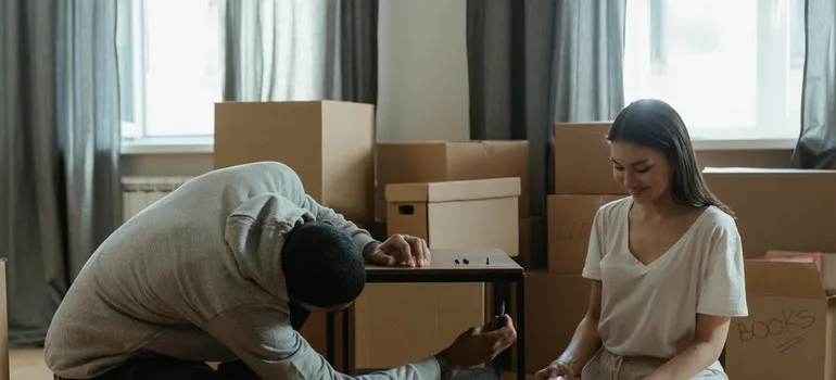 A couple installing a table in order to settle after moving to Chevy Chase.