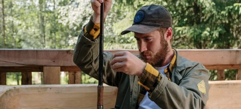 a man inspecting his fishing rod