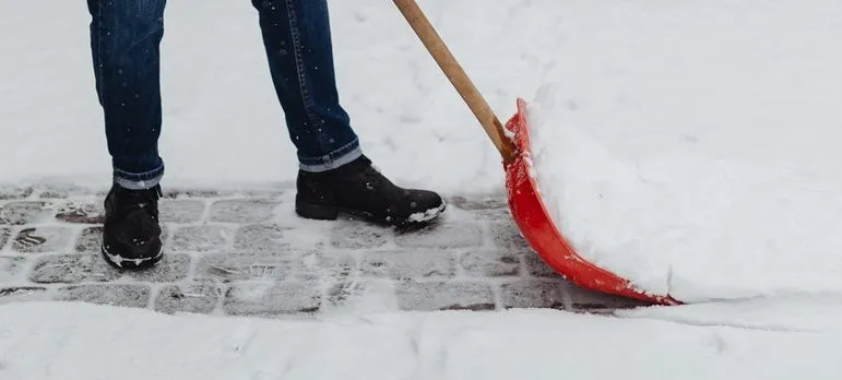 man about to get home winter-ready by cleaning driveway