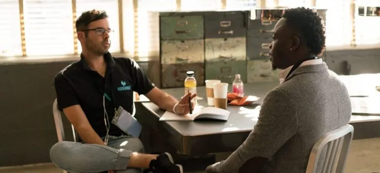 two people conversating inside an office