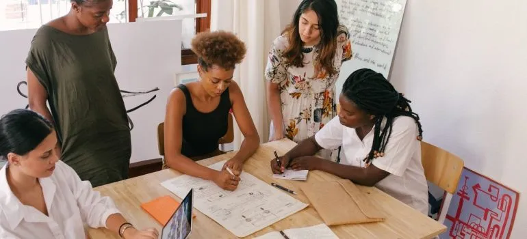 a team of coworkers working together to plan an office move in MD