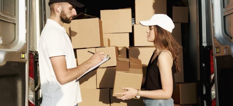 man and woman checking boxes