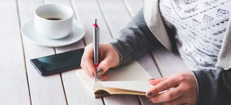 person creating a checklist to get ready for moving from West Virginia to McLean