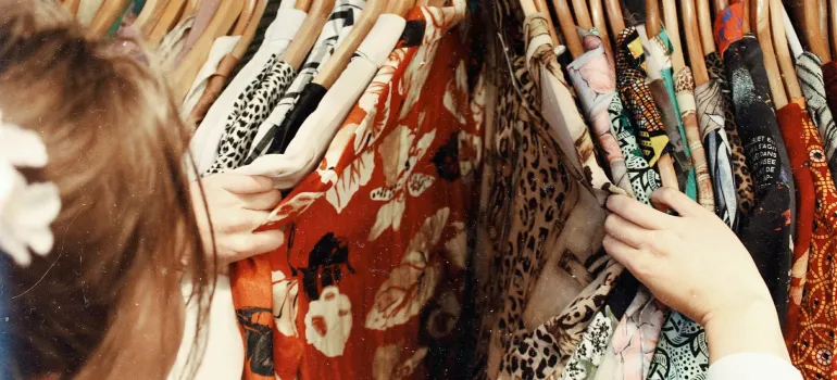 a woman going through her wardrobe