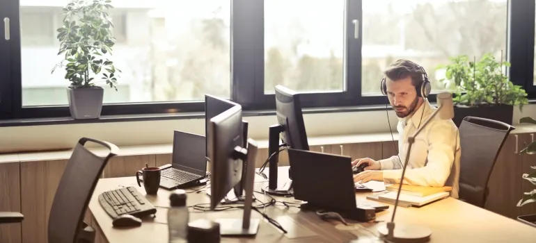 A man sits at a computer and works.
