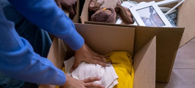 two people packing boxes for moving