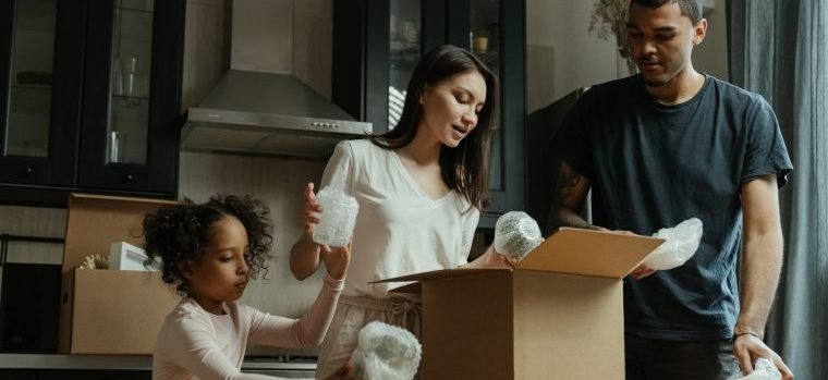 A family unpacking their box with essentials