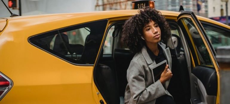 a woman leaving the yellow cab