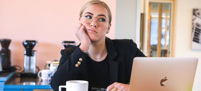 a bored woman in front of a laptop