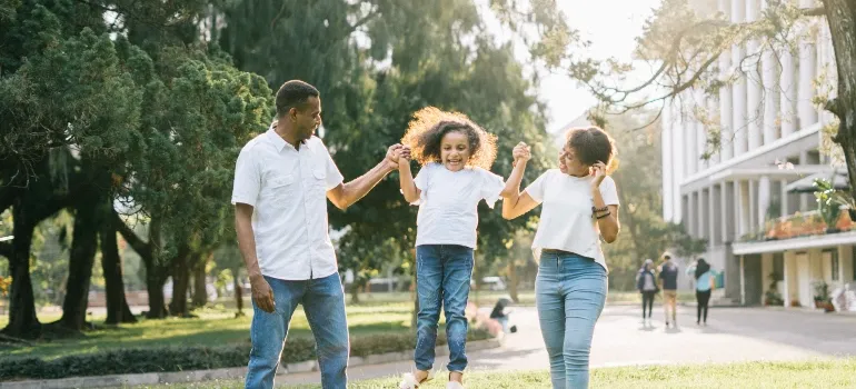 parents playing with their daughter after choosing among the best places in Maryland to move to in 2022