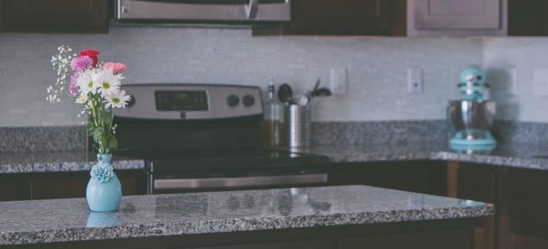 flowers in a vase on a kitchen counter