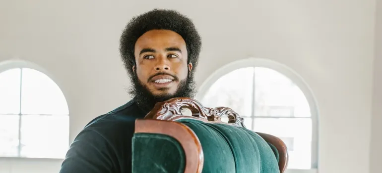 mover carrying the chair which is not something Arlington movers will refuse to move