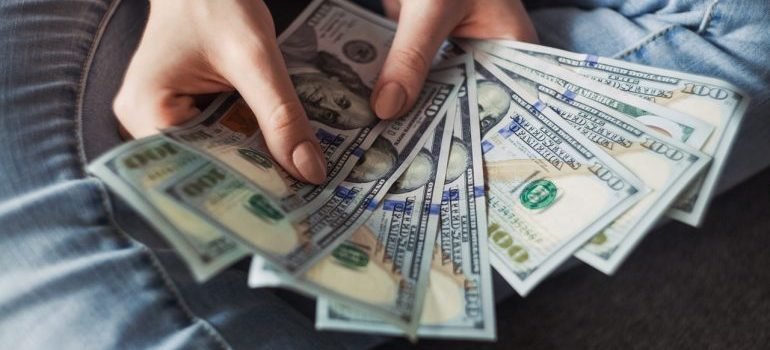 a person holding 100 us dollar bills