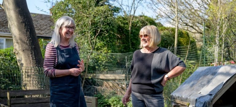 two women standing and talking about best places to open a small business in maryland