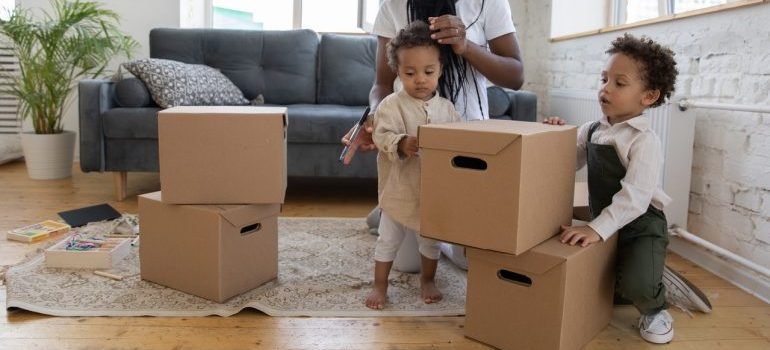 Woman and two kids packing boxes