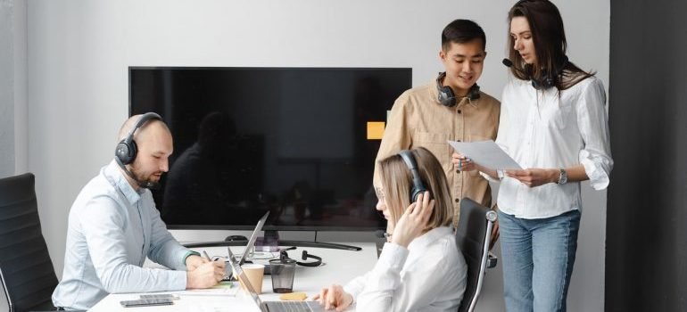 a group of people with headsets in an office