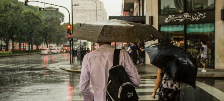 a man in a white shirt holding an umbrella