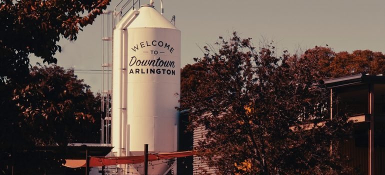 white water tank with welcome to downtown arlington written on it