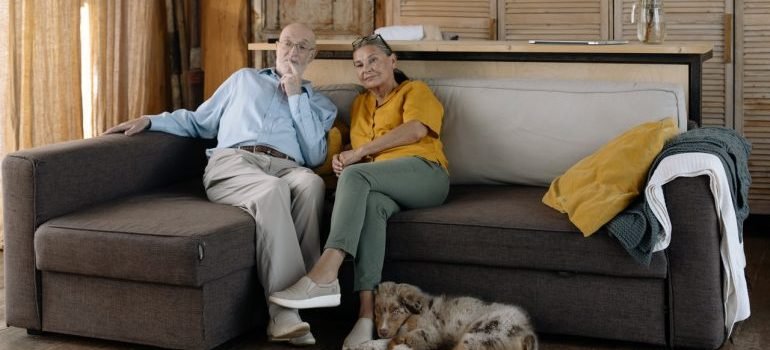 Senior couple sitting on sofa in senior-friendly Montgomery County