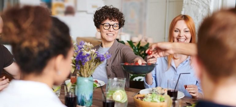 people sitting around the table sharing food