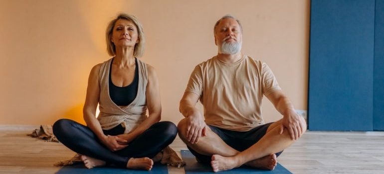 Elderly couple practicing yoga