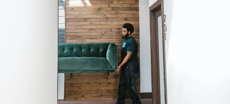 mover carrying a sofa