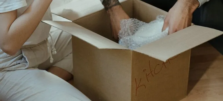 Couple getting ready to pack fragile items when moving across Virginia